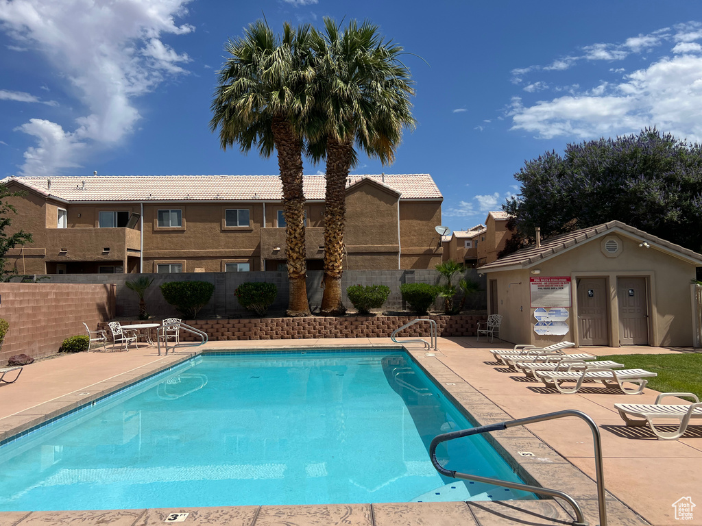 Community pool with a patio
