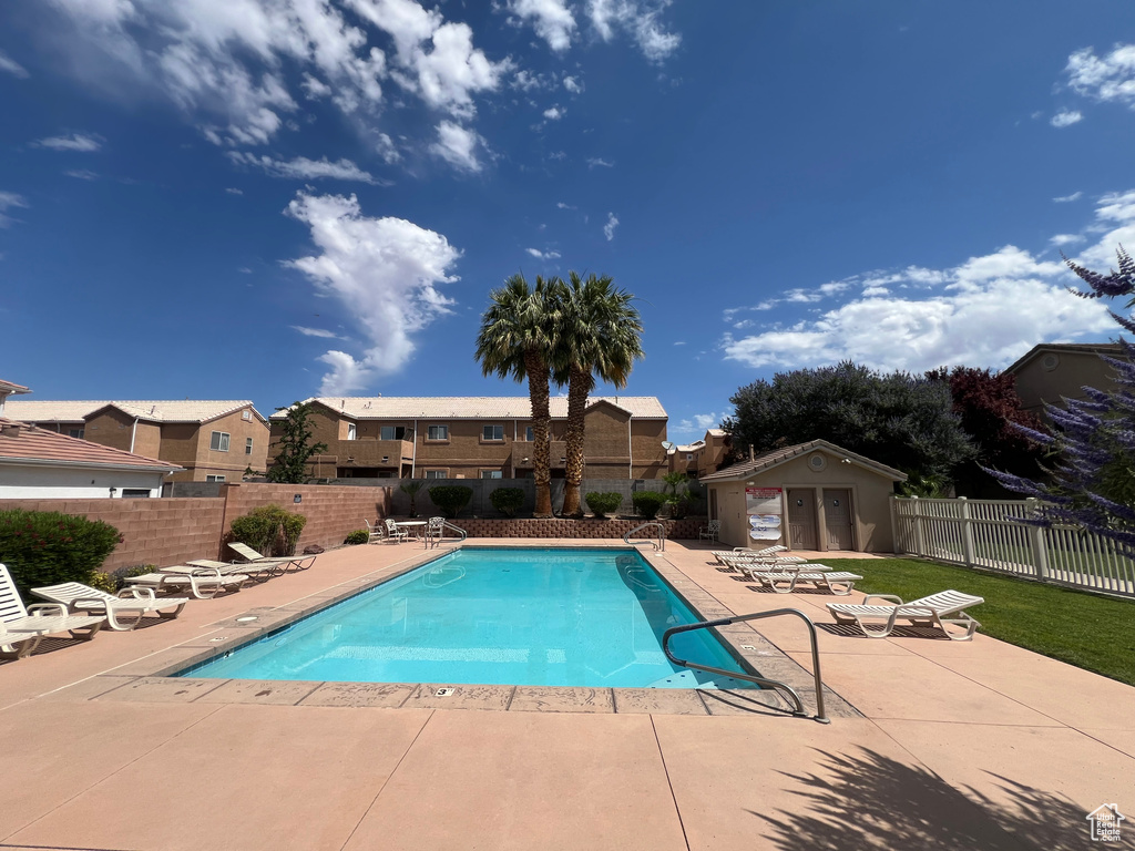 Community pool featuring a patio and a residential view
