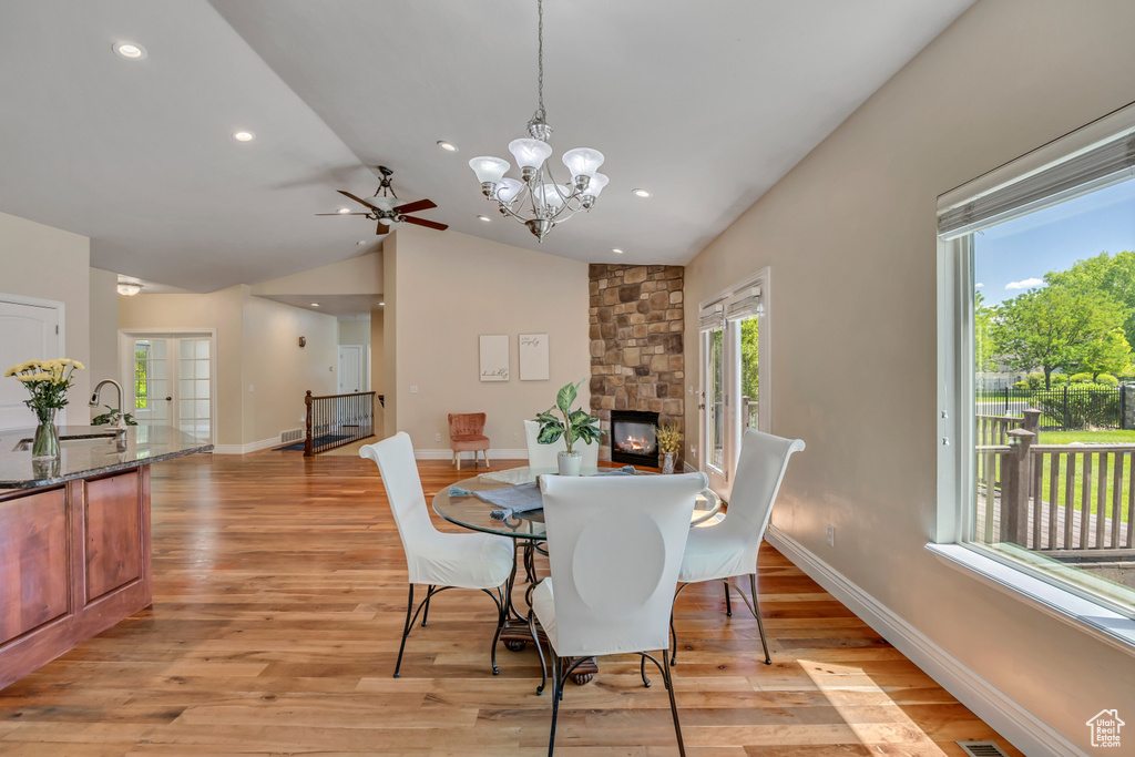 Dining room featuring plenty of natural light, lofted ceiling, baseboards, ceiling fan, and recessed lighting
