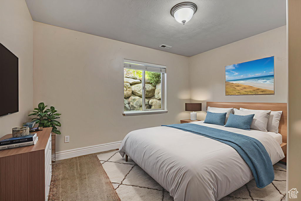 Bedroom featuring baseboards and carpet flooring