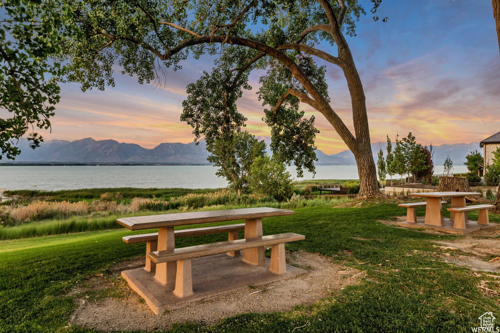 View of community featuring a lawn and a water and mountain view