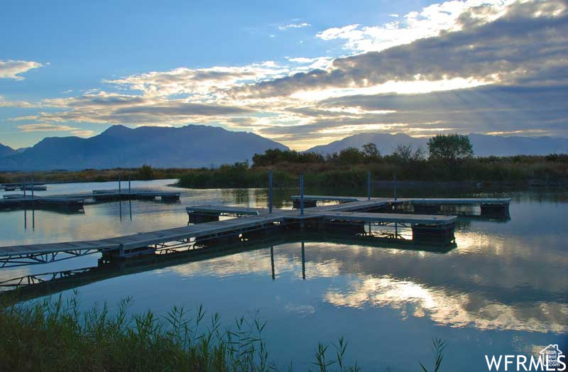 Dock featuring a water and mountain view