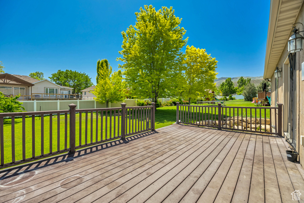 Wooden terrace featuring a mountain view and a residential view