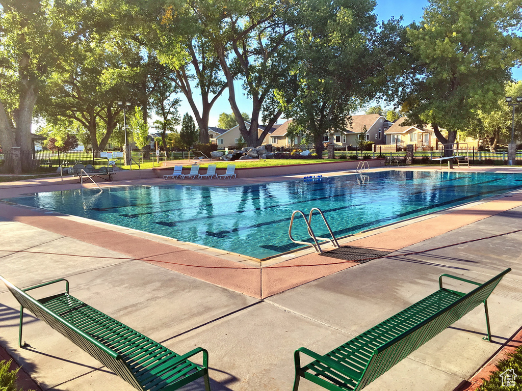 Community pool with a patio