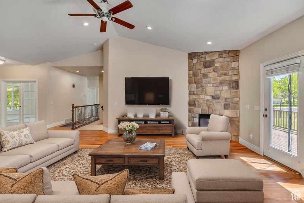 Living room featuring ceiling fan, plenty of natural light, light wood-type flooring, lofted ceiling, and recessed lighting