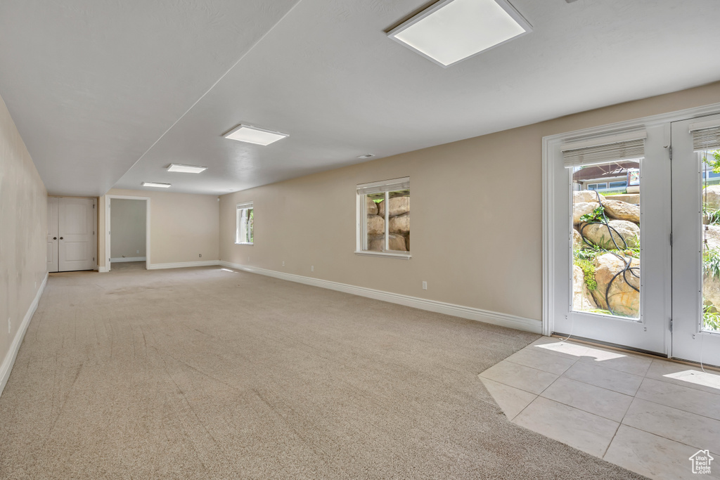 Unfurnished room with light carpet and baseboards