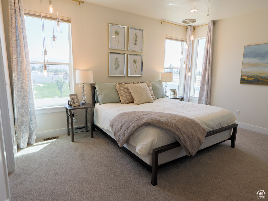 Carpeted bedroom with baseboards