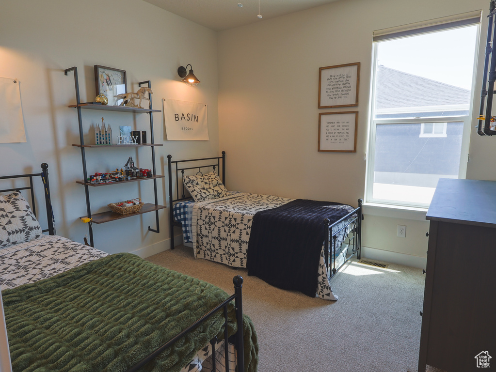 Carpeted bedroom with baseboards