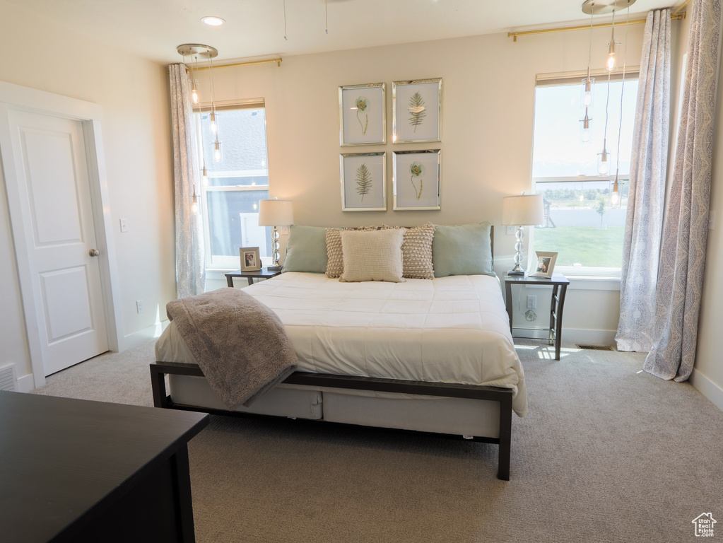 Bedroom featuring carpet floors and baseboards