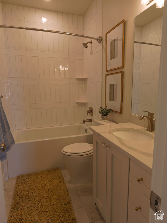 Full bathroom featuring toilet, vanity, bathing tub / shower combination, and tile patterned floors