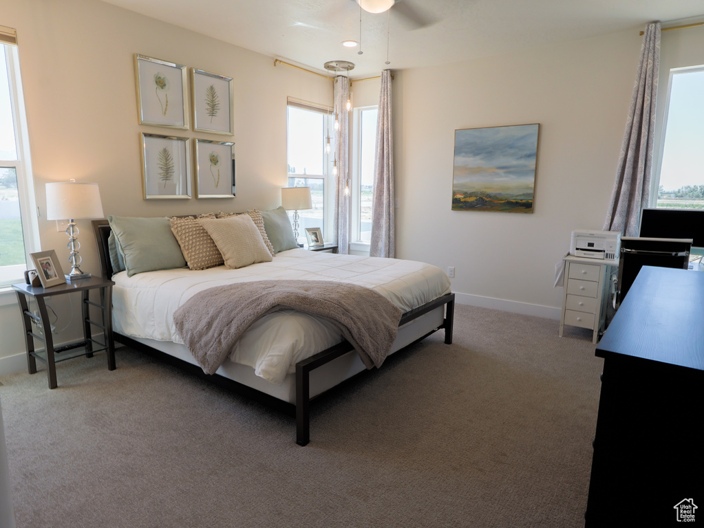 Bedroom featuring carpet floors and baseboards