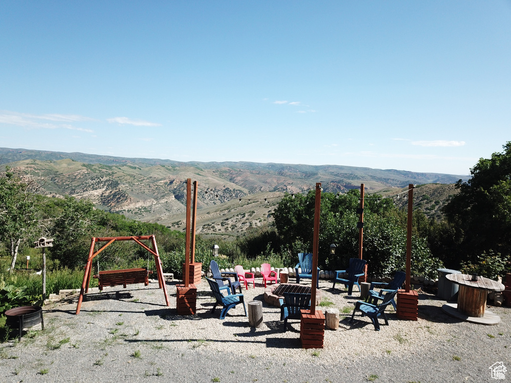 View of community featuring a fire pit and a mountain view