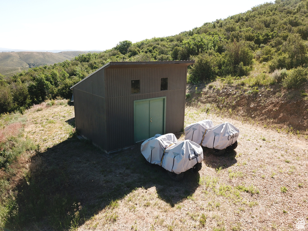 View of outdoor structure with a wooded view