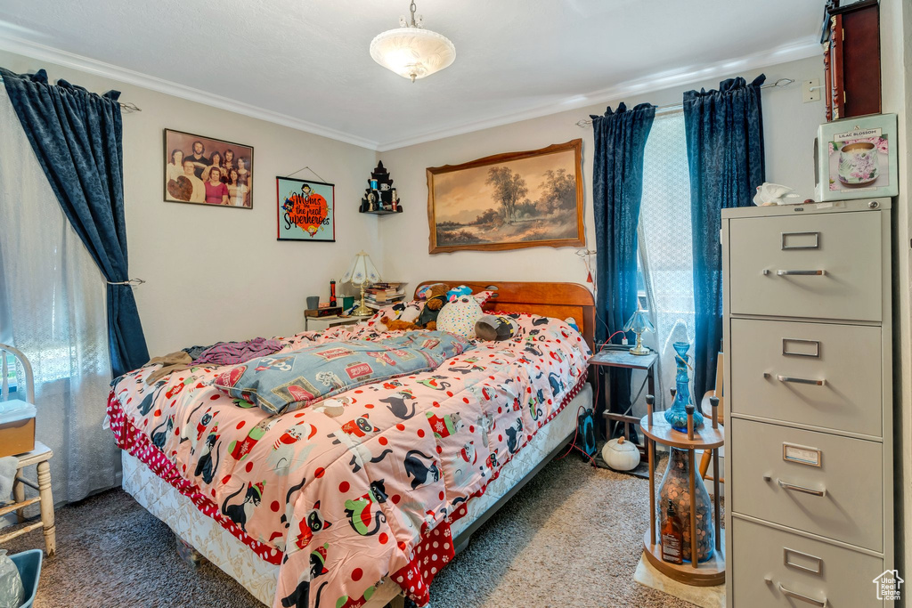 Bedroom with carpet floors and crown molding