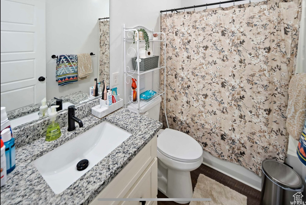 Full bath with vanity, toilet, and a shower with curtain