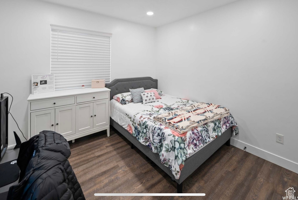 Bedroom with dark wood-style floors, baseboards, and recessed lighting