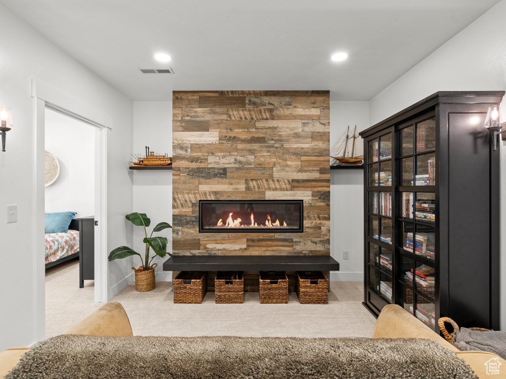 Carpeted living area featuring a fireplace, recessed lighting, and baseboards