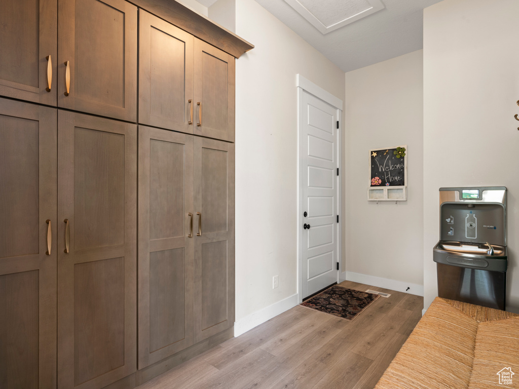 Entryway with light wood-style floors and baseboards