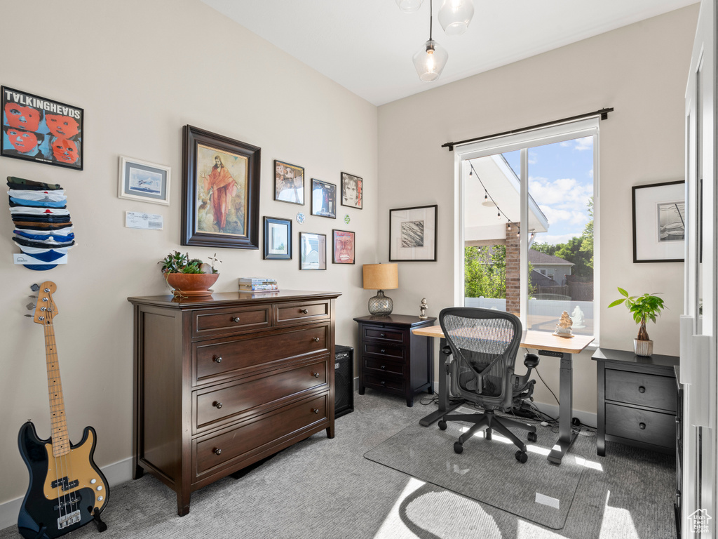 Home office featuring light carpet and baseboards