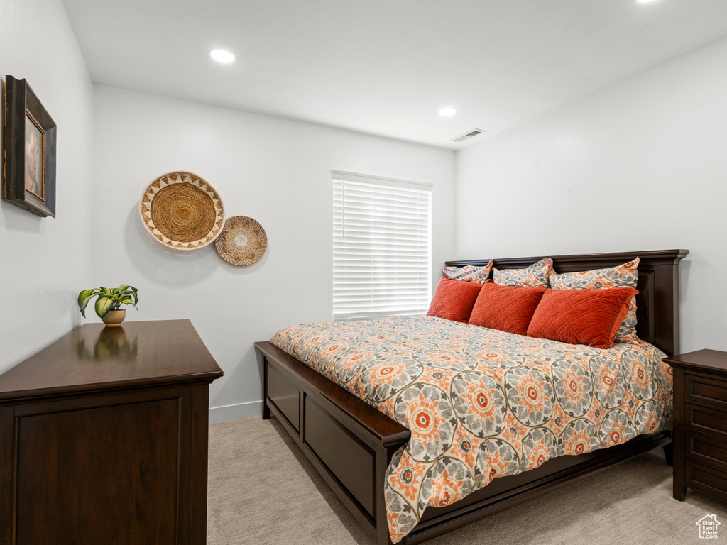 Bedroom featuring light carpet, recessed lighting, and baseboards