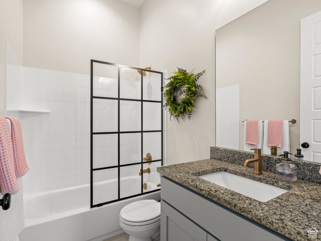 Bathroom featuring vanity, toilet, and shower / tub combination