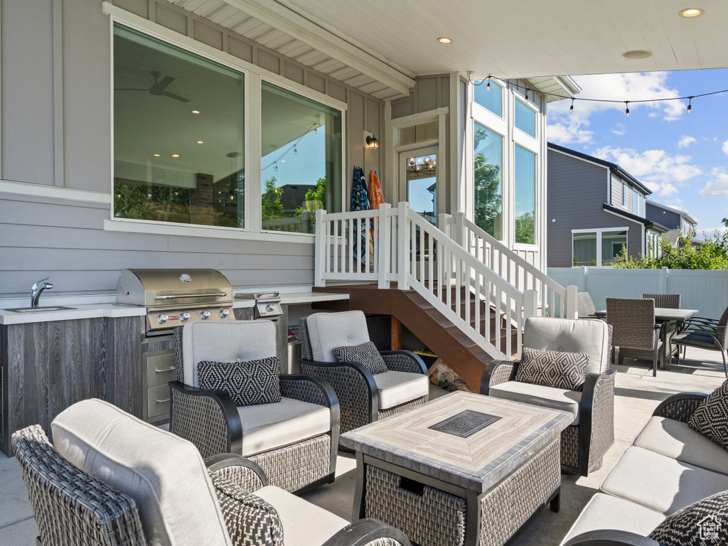 View of patio / terrace featuring a grill, outdoor dining area, a sink, and an outdoor living space with a fire pit