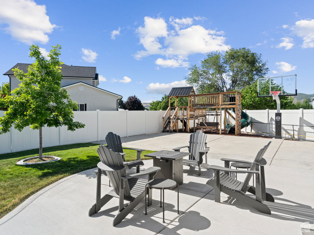 View of patio / terrace with a playground and a fire pit