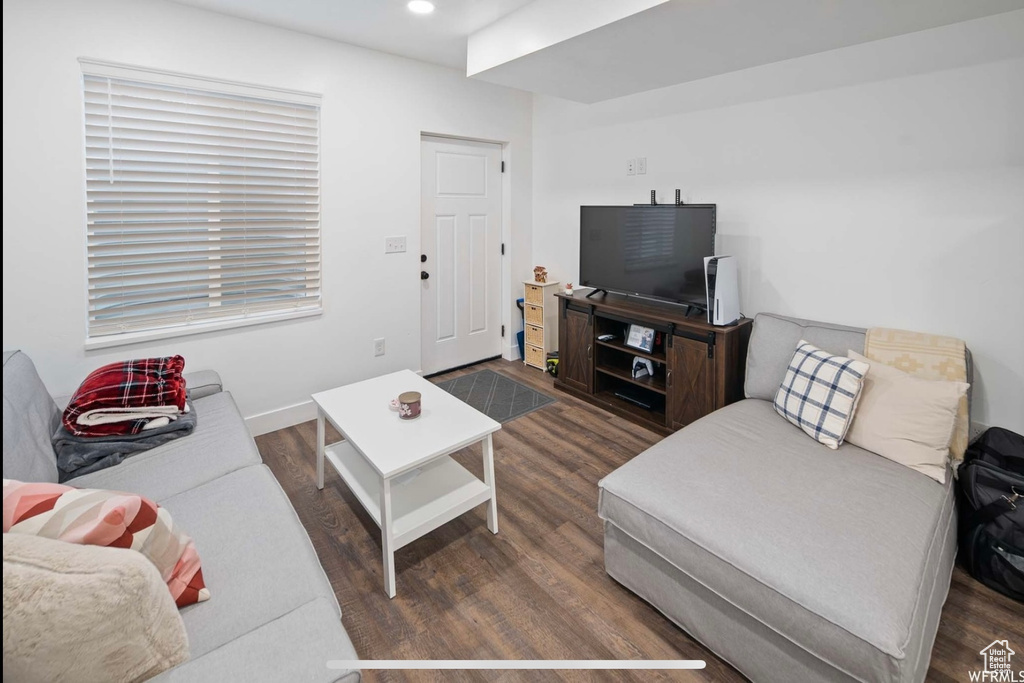 Living area with wood finished floors, recessed lighting, and baseboards