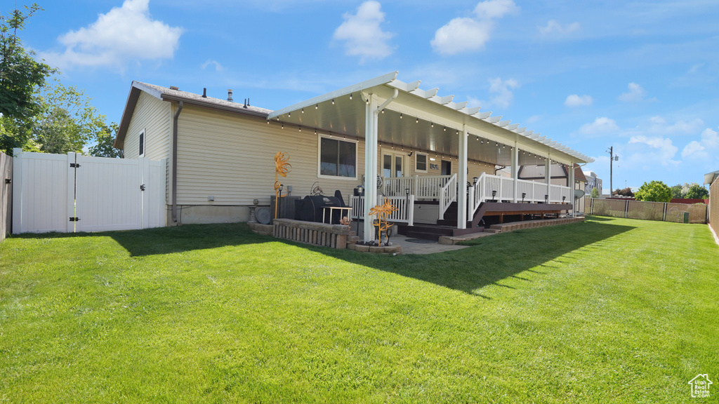Back of property featuring a deck and a gate