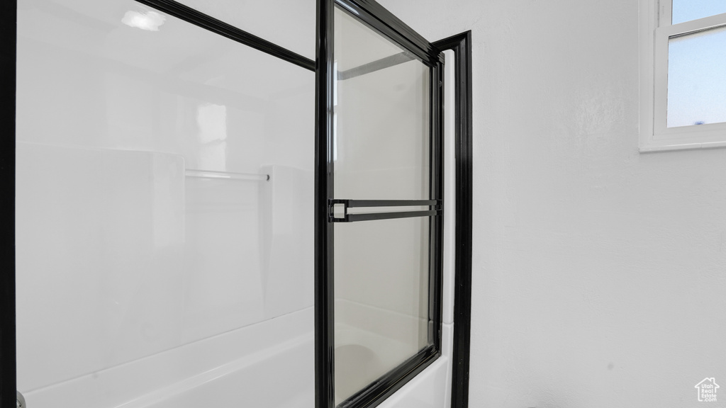 Full bathroom featuring bath / shower combo with glass door