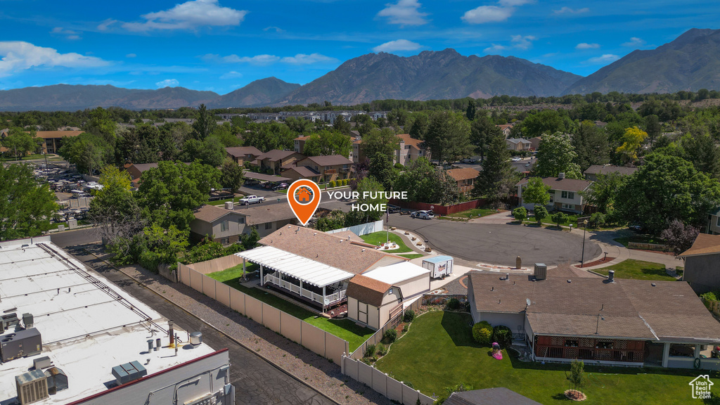 Aerial perspective of suburban area featuring a mountainous background