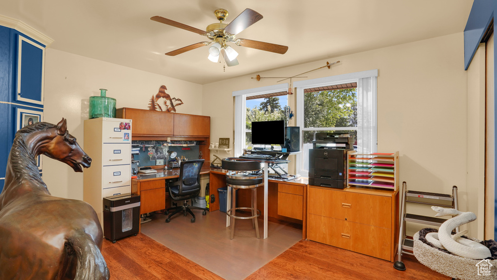 Home office with wood finished floors and ceiling fan