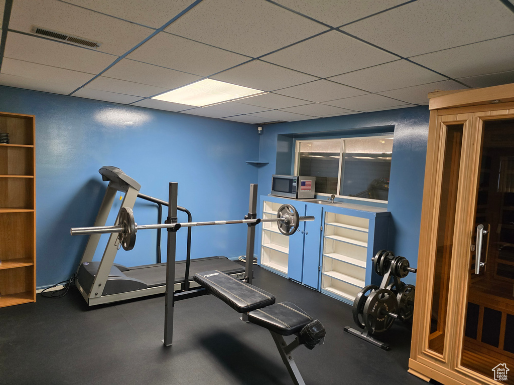 Exercise area featuring a drop ceiling
