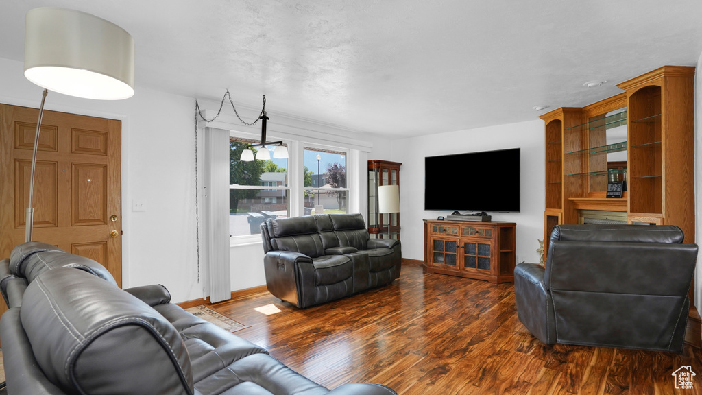 Living room with dark wood finished floors and baseboards