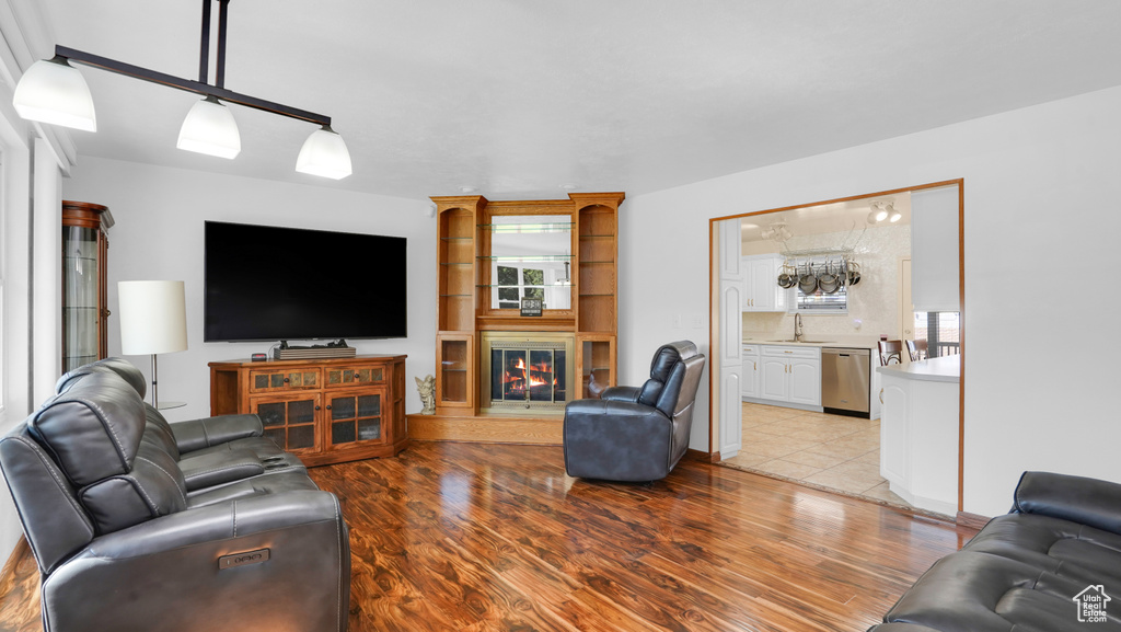 Living room featuring healthy amount of natural light, a fireplace, and wood finished floors
