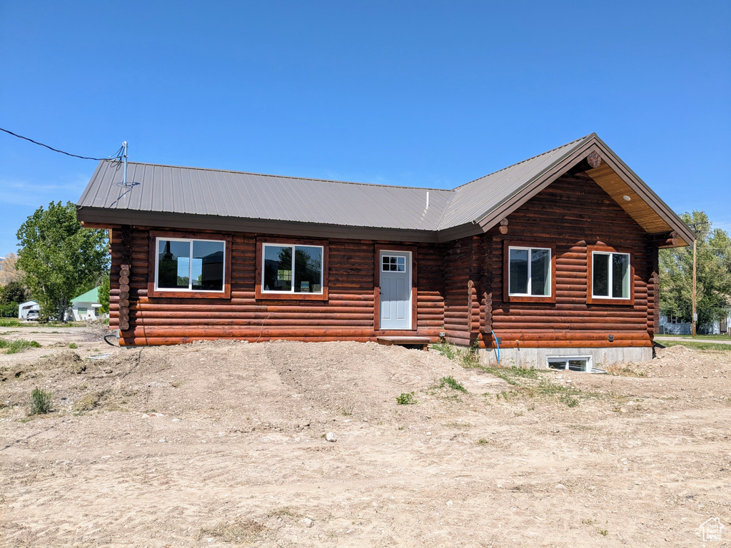 Cabin featuring log exterior and metal roof
