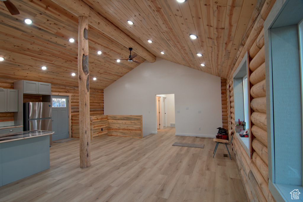 Unfurnished living room with log walls, a ceiling fan, light wood-style floors, wood ceiling, and recessed lighting