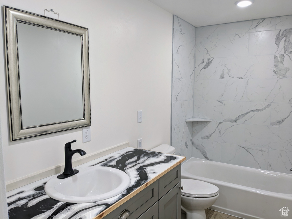 Bathroom featuring vanity, toilet, and shower / bath combination