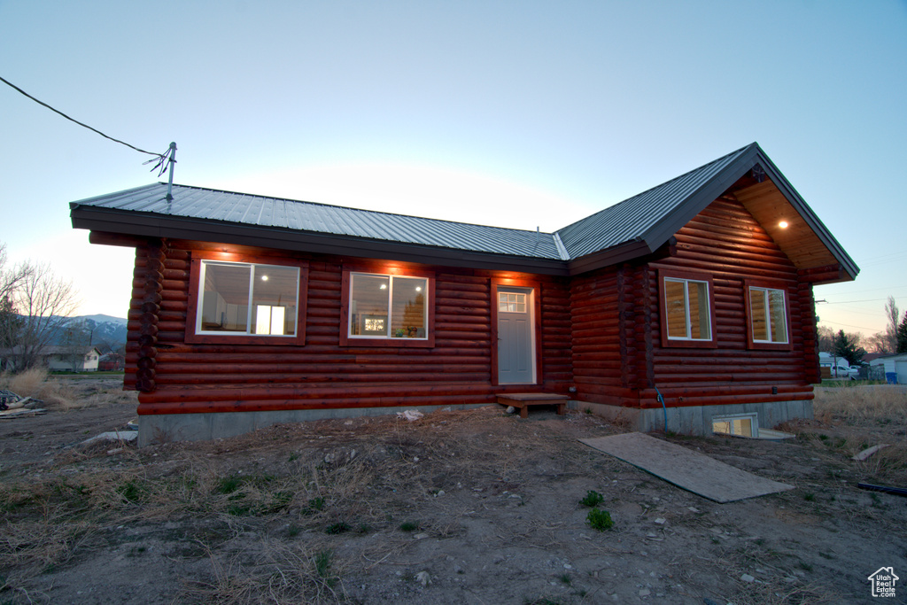 Cabin with log exterior and metal roof