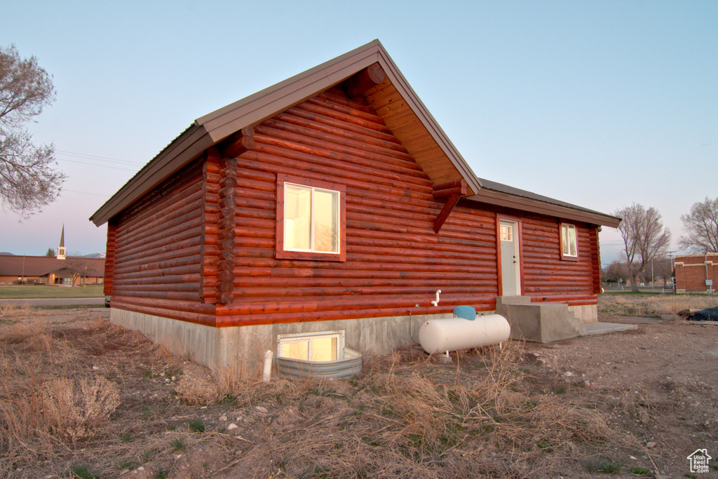 Property exterior at dusk with log exterior