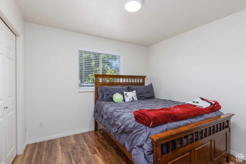 Bedroom featuring wood finished floors and baseboards