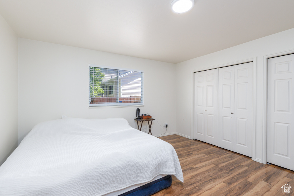 Bedroom featuring wood finished floors and baseboards