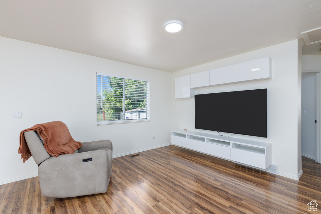 Living area featuring wood finished floors and baseboards