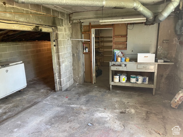 Unfinished below grade area with concrete block wall