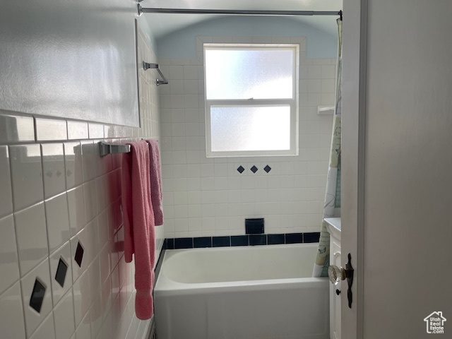 Full bathroom with shower / tub combo with curtain