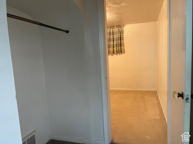 Walk in closet featuring carpet flooring