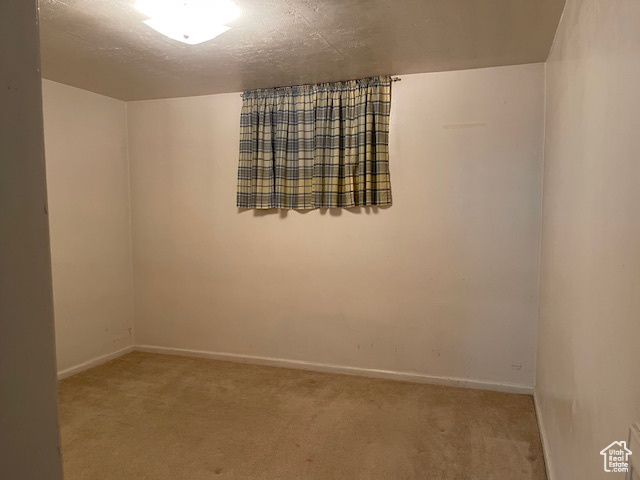 Unfurnished room with carpet floors and baseboards