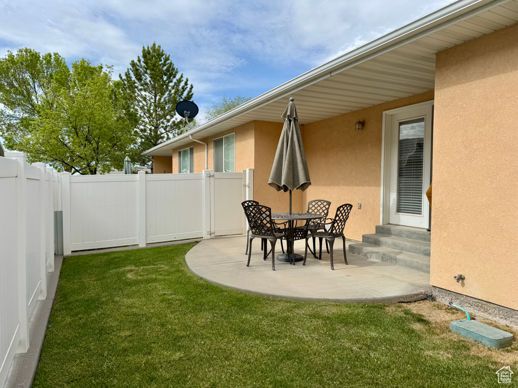 View of yard with entry steps and a patio