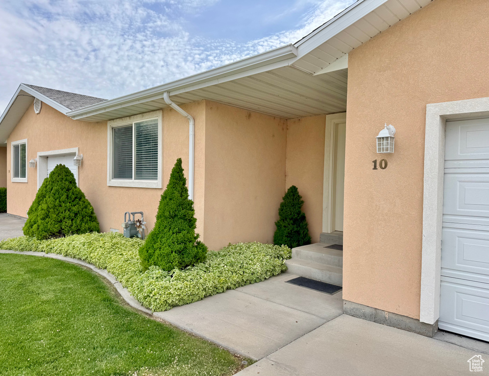 Entrance to property featuring stucco siding