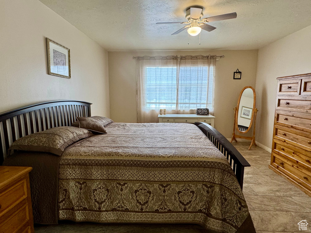 Bedroom featuring a textured ceiling and ceiling fan